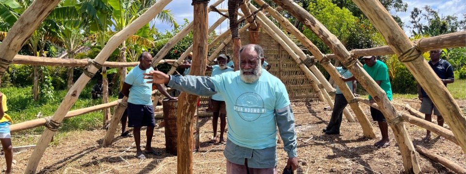 An Erromangan chief inside the frame of a traditional Erromangan building